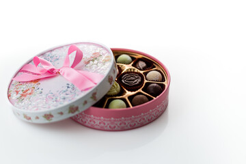 Chocolates in pink box with ribbon