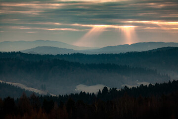 Sunrise in the mountains with sunrays from the sky, Bieszczady, Poland