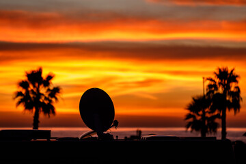 camper van satellite dish against sunset