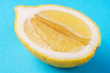 Lemon half on blue background.