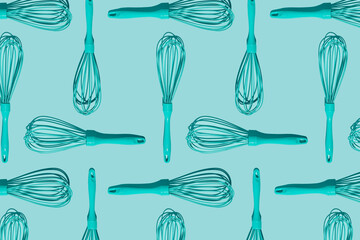 Monochromatic pattern made with egg beater, manual hand mixer on turquoise background.