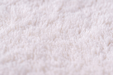 Closeup of a white towel. Texture of white soft terry blanket textile.