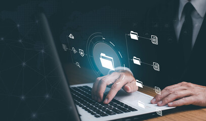 Online documentation database and document management system concept. Businessman working on laptop with virtual screen. Process automation to efficiently manage files.