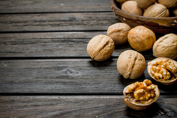 Peeled walnut on wooden background.