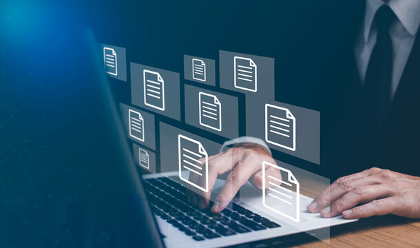 Businesswoman working on laptop with virtual screen. Process automation to efficiently manage files. Online documentation database and document management system concept.