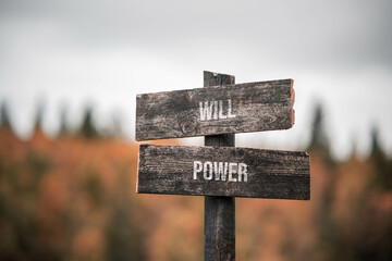 vintage and rustic wooden signpost with the weathered text quote will power, outdoors in nature....