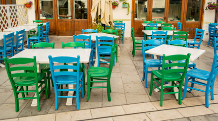 Fototapeta na wymiar View of a restaurant with green chairs in Grado, Friuli Venezia Giulia, Italy