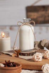 Milk in a bottle with a bow on a light background