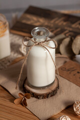 Milk in a bottle with a bow on a light background