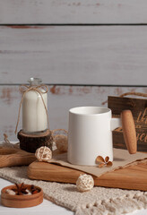A cup with a drink and milk in a bottle on the table