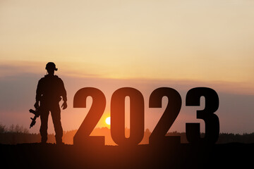 Silhouette of soldier and 2023 against the sunrise or sunset. Armed forces. Concept of military conflicts in 2023.