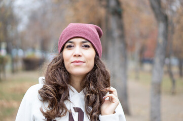 Portrait of a beautiful young woman in the park. A woman with long beautiful hair on a walk in the park.