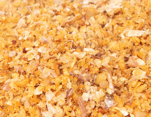 Close Up Pile of Fried Garlic, golden yellow fried garlic group stack. Beautiful fried garlic ready to serve on top of food dish, food object design. White background isolated