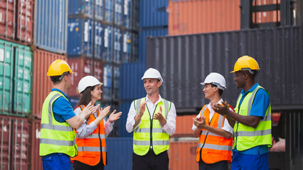 Employees applauding manager during meeting in a factory. worker teamwork encouraging team. International shipping import Export shipyard business concept. Industrial and working in container yard