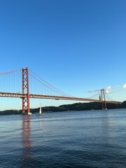 The April 25 Bridge is a suspension bridge connecting Lisbon on the north (right) and Almada on the south (left) bank of the Tagus River.