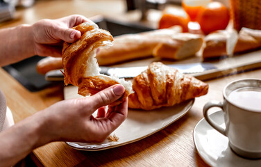 Coffee cup and croissants at kitchen table
