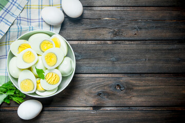 Boiled eggs in a bowl with parsley.