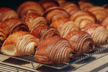 Close-up of fresh and beautiful pain au chocolats in a bakery showcase.