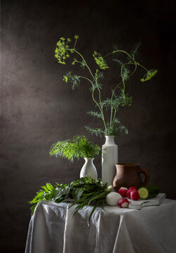 Spring still life with dill in a vase, vegetables and herbs