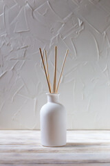 Aromatic reed diffuser on a white background. Vertically