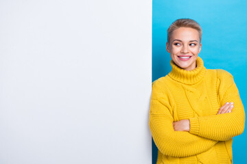 Photo of gorgeous cheerful lady demonstrate empty space opening new boutique low prices clothes isolated on blue color background
