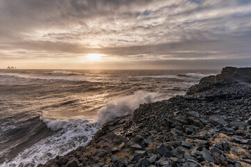 Black Sand Beach Reynisfjara in Iceland. Windy Morning. Ocean Waves and Rocks