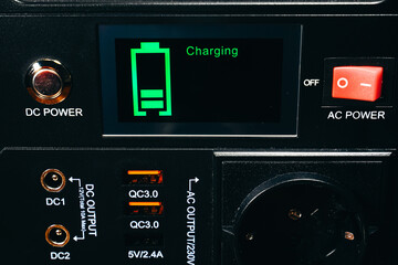 Fototapeta premium Control panel display of lithium Portable Power Station. Charging laptop smartphones, power banks and other gadgets. Modern, information technology.