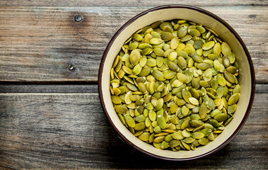 Pumpkin seeds in bowl .