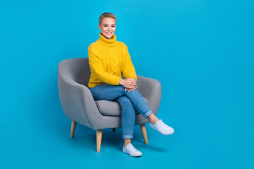 Fototapeta na wymiar Full length photo of stunning adorable lady wear trendy clothes sitting office room take interview isolated on blue color background
