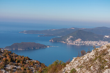 Fototapeta na wymiar Panoramic aerial view on the coastline of Budva and Sveti Nikola Island seen from Goli Vrh, Adriatic Mediterranean Sea, Montenegro, Balkan, Europe. Luxury hotel resorts along Budvanian Riviera.