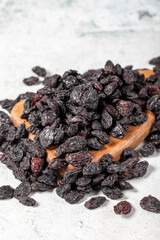 Dried black grapes on stone background. Dried grapes on a wooden serving board. Nuts varieties. Healthy eating. close up