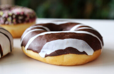 Sweet and colorful donuts glazed with sprinkles and frosting. Set of different types of doughnuts on white background. Sweet day.Valentine's day concept.