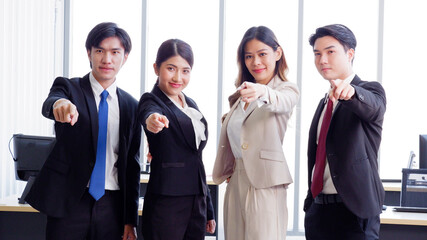 Businessmen and employees standing and smiling in the office business idea