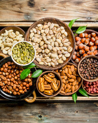 Assortment of different nuts in bowls.