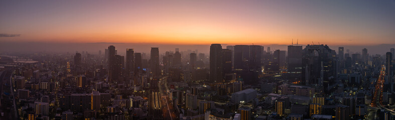 Fototapeta na wymiar Panoramic aerial view of Osaka City on hazy morning before sunrise