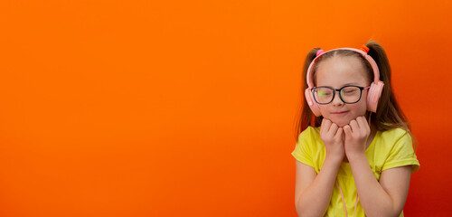 Girl with Down syndrome listens to music. Banner