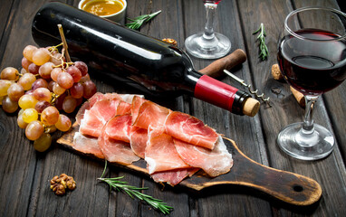 Traditional Spanish ham with grapes and red wine.