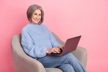 Photo of cheerful optimistic businesswoman retired lady grey bob hair typing keyboard new laptop remote copywriter isolated on pink color background