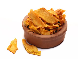 Dried mango slices in clay pot isolated on white, side view