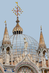 View over decoration elements at roofs and cupolas of Basilica San Marco in Venice, Italy, at sunny day and deep blue sky.