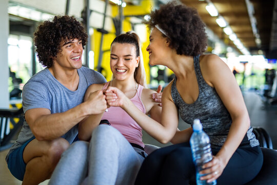 Fitness, sport, people and lifestyle concept. Group of smiling people exercising together in gym