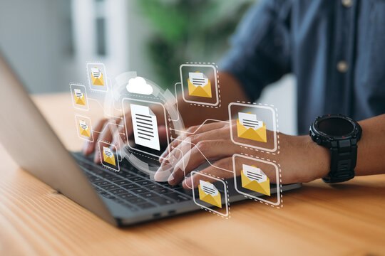 Online documentation database and document management system concept. A businessman works on his laptop with a virtual screen. Process automation is needed to efficiently manage files.