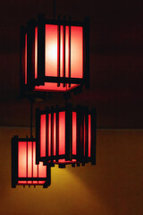 Rectangular red lamps in a restaurant on a dark background © fotosenukas