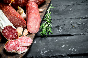 Different types of salami with spices and herbs.
