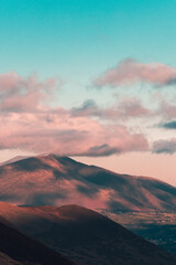 Fototapeta na wymiar Sunset landscape of mountains and pink clouds in the azure sky