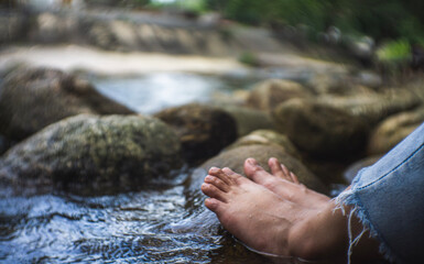 Feet immersed in the clear water of the lake.