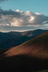 Sunset landscape of mountains and pink clouds in the azure sky