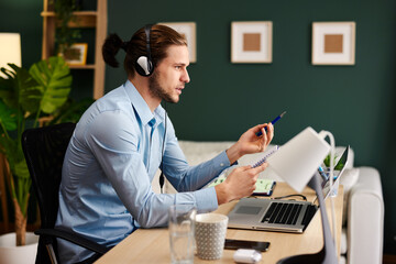 Young man working as customer support in the office