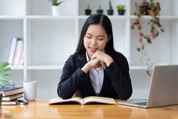 Portrait of beautiful asian businesswoman working with laptop in office.