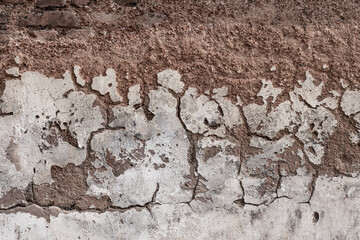 Aged brick wall with damaged plaster